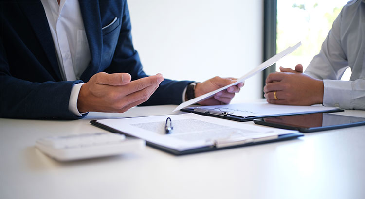 Person with Mortgage Lender signing paperwork
