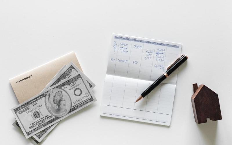 Photo representing money and a checkbook for an earnest money deposit