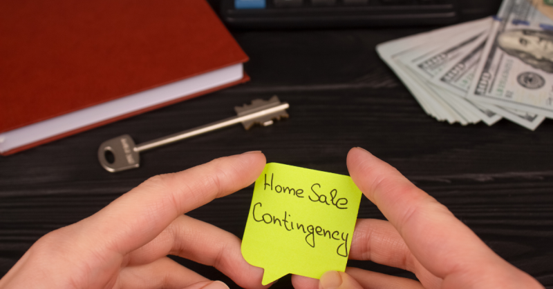 A set of hands holding a note that says Home Sale Contingency